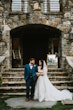 Bride Wearing Shimmery Princess Bridal Gown Called Tiffany By Maggie Sottero With Groom In Front of Reception Hall