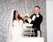 Bride in lace motif wedding dress called Alistaire by Maggie Sottero with groom at reception