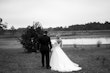 Bride In Off The Shoulder Lace Wedding Dress Called Tiffany By Maggie Sottero With Groom