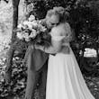 Bride Wearing Chiffon A-Line Wedding Dress Called Heather By Rebecca Ingram Hugging Her Grandpa