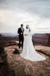 Groom Reading Vows To Bride Wearing A White A Line Wedding Dress Named Keisha By Maggie Sottero Outside On Red Rocks