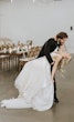 Groom Dancing With Bride Wearing Plunging Lace Illusion Wedding Dress Called Raelynn By Rebecca Ingram