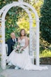 Bride Wearing Sexy Lace Wedding Dress Called Lennon By Maggie Sottero With Groom On A Garden Bench