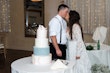 Bride Wearing Dreamy Long Bishop Lace Sleeve Wedding Dress Called Finley By Sottero And Midgley Kissing Groom By Wedding Cake