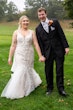 Bride wearing Wendi wedding dress by Rebecca Ingram holding hands with her husband