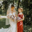 Bride wearing Marguerite wedding dress by Maggie Sottero with a flower girl