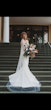 Bride Wearing Simple Fit And Flare Wedding Dress Called Francine By Rebecca Ingram Standing On A Staircase