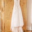 Boho Sheath Wedding Dress Called Marisol By Rebecca Ingram Hanging From An Armoir
