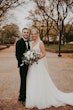 Bride with groom wearing affordable sparkly ballgown wedding dress.