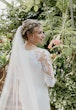 Bride wearing Bethany wedding dress by Rebecca Ingram looking over her shoulder