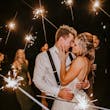 Bride Wearing Sparkly Ballgown Wedding Dress Called Shasta By Sottero And Midgley With Groom And Sparklers Surrounding Them
