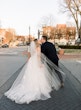 Bride wearing Hattie Lane Marie wedding dress by Rebecca Ingram kissing her husband