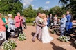 Bride wearing Demetria by Maggie Sottero kissing her husband at their ceremony