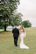 Bride wearing Clover by Rebecca Ingram walking with her husband