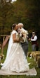 Bride wearing Kingsley wedding gown by Sottero and Midgley kissing her husband