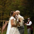 Bride wearing Kingsley wedding gown by Sottero and Midgley kissing her husband
