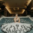 Bride wearing Tristyn wedding dress by Maggie Sottero sitting on stairs