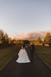 Bride wearing Derrick by Maggie Sottero holding hands with her husband