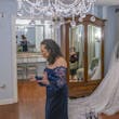 Bride wearing Seneca wedding dress by Sottero and Midgley looking out the window