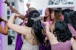 Back view of the bride with her bridesmaids in purple gowns.