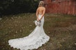 Back of bride wearing a lace backless wedding dress.