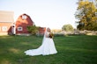 Bride Standing in Barn Feild in Savannah Wedding Dress Called Savannah by Maggie Sottero.