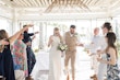 Bride wearing Davis Leigh wedding dress by Sottero and Midgley and her husband at their exit