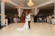 Bride Wearing Simple Fit and Flare Wedding Dress Called Anniston Lane Dancing With Groom