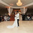 Bride Wearing Simple Fit and Flare Wedding Dress Called Anniston Lane Dancing With Groom