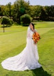 Bride Wearing Lace Long Sleeve Aline Wedding Dress Called Winter By Maggie Sottero Holding Orange And Yellow Bouquet