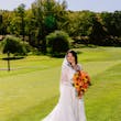 Bride Wearing Lace Long Sleeve Aline Wedding Dress Called Winter By Maggie Sottero Holding Orange And Yellow Bouquet
