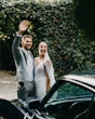 Bride wearing Fontaine by Maggie Sottero waving with her husband