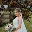 Bride wearing Lettie wedding dress by Rebecca Ingram holding a bouquet