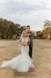 Bride Wearing Pink Lace Mermaid Wedding Dress Called Kenleigh By Sottero And Midgley With Groom In A Field