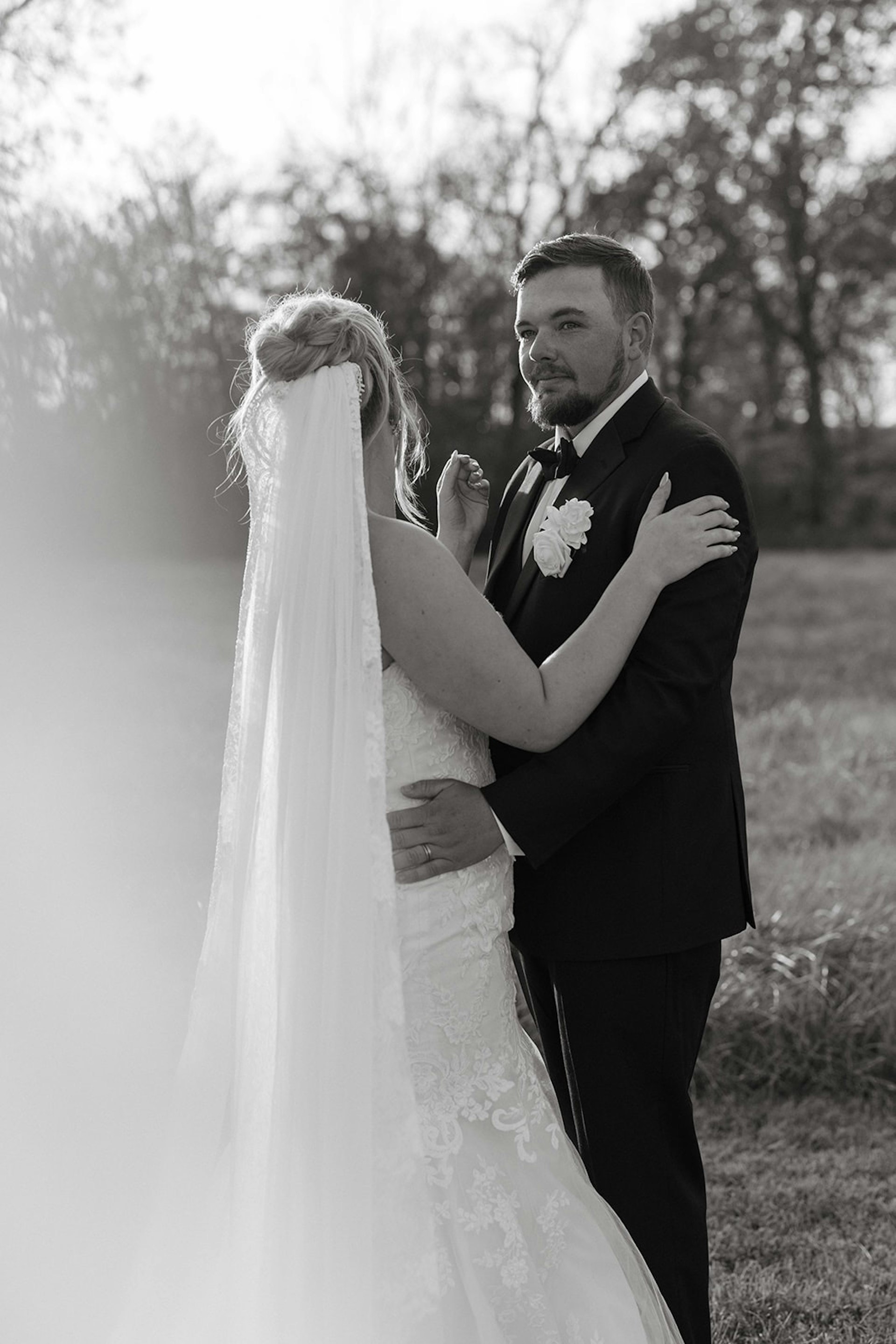 Bride Wearing Lace Mermaid Wedding Gown Called Toccara By Maggie Sottero With a Long Simple Veil With Groom