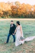 Bride Wearing Crepe Sheath Wedding Dress Called Alda By Rebecca Ingram Walking With Groom