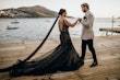 Bride Wearing Black Fit And Flare Wedding Dress Called Zander Lane By Sottero And Midgley With Groom On A Pier