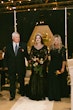 Bride Wearing Black Lace Wedding Dress Called Zander Lane By Sottero And Midgley Walking Down The Aisle With Parents