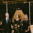 Bride Wearing Black Lace Wedding Dress Called Zander Lane By Sottero And Midgley Walking Down The Aisle With Parents