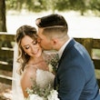 Bride with groom wearing affordable floral ballgown wedding dress.