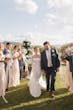 Bride Wearing Simple Mermaid Wedding Dress Called Mitchell By Maggie Sottero Walking Down The Aisle With Groom And Wedding Party