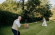 Bride wearing Lorraine by Rebecca Ingram playing tug of war