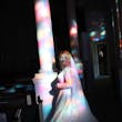 Bride Standing In Colorful Lights. Bride Wearing Romantic A-Line Long Sleeve Dress Called Raphael By Maggie Sottero
