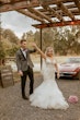 Bride Wearing Pink Lace Mermaid Wedding Dress Called Kenleigh By Sottero And Midgley Holding Hands With Groom