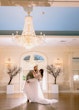 Bride Wearing Lace Long Sleeve Aline Wedding Dress Called Winter By Maggie Sottero With Groom Under A Chandelier