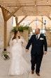 Bride wearing Hattie by Rebecca Ingram walking with her husband