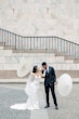 Bride wearing Moon by Maggie Sottero having her hand kissed by her husband