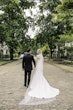 Bride wearing Mitchell Marie Vida by Maggie Sottero walking with her husband