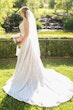 bride in lace train  wedding dress called roxanne by sottero and midgley