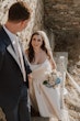 Bride wearing Aspen by Sottero and Midgley walking up the stairs with her husband